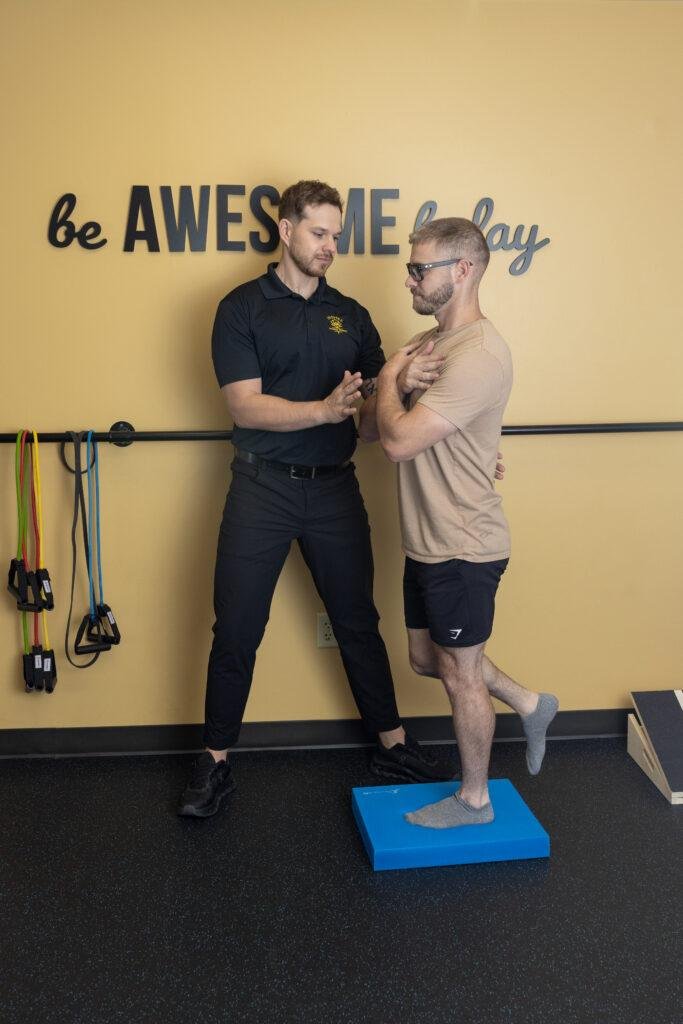 Physical therapist guiding balance exercise session