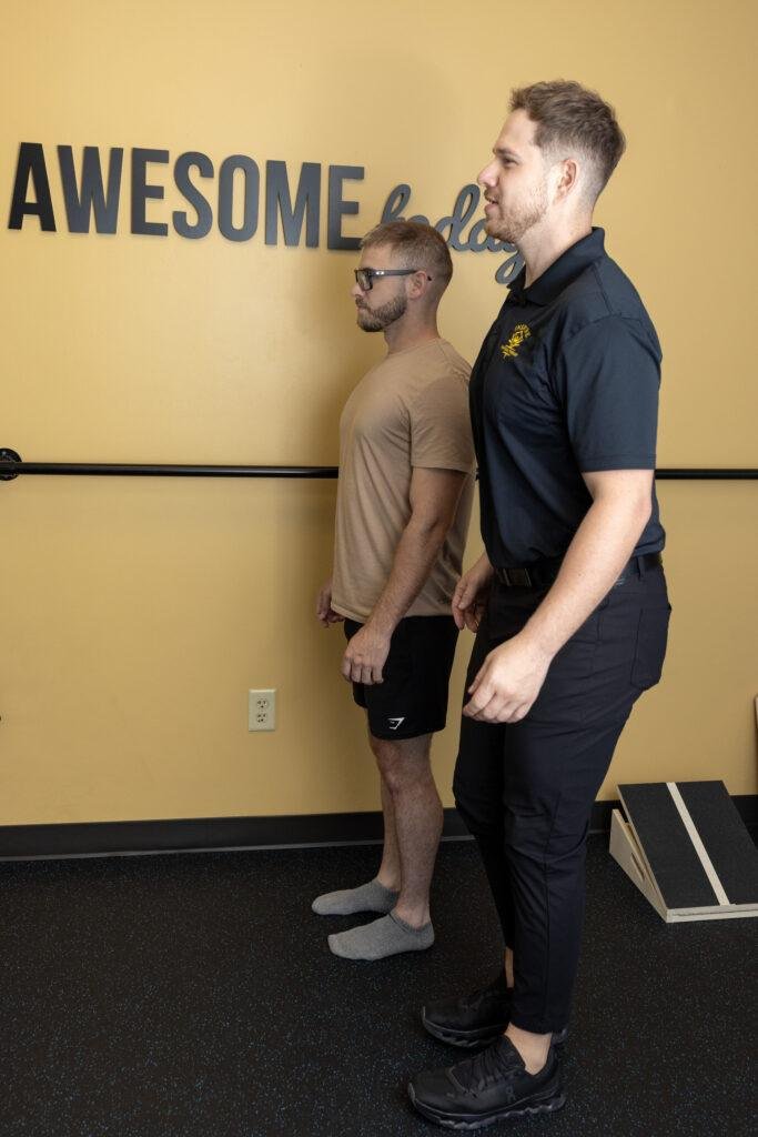 Two men practicing posture alignment indoors