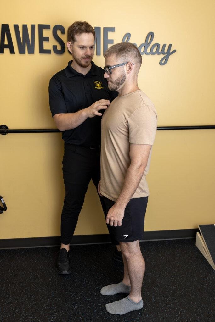 Physical therapist guiding patient during posture exercise