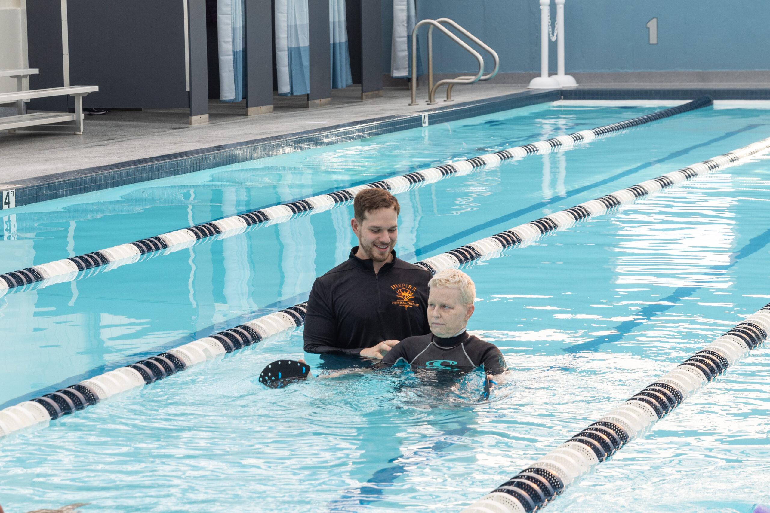 Physical therapist and patient performing aquatic therapy.